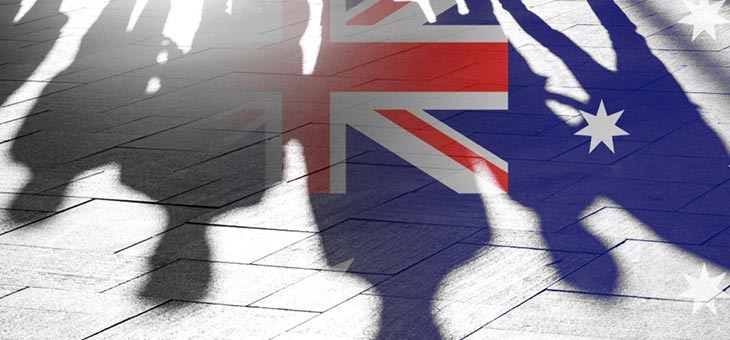 silhouettes of migrants and an australian flag